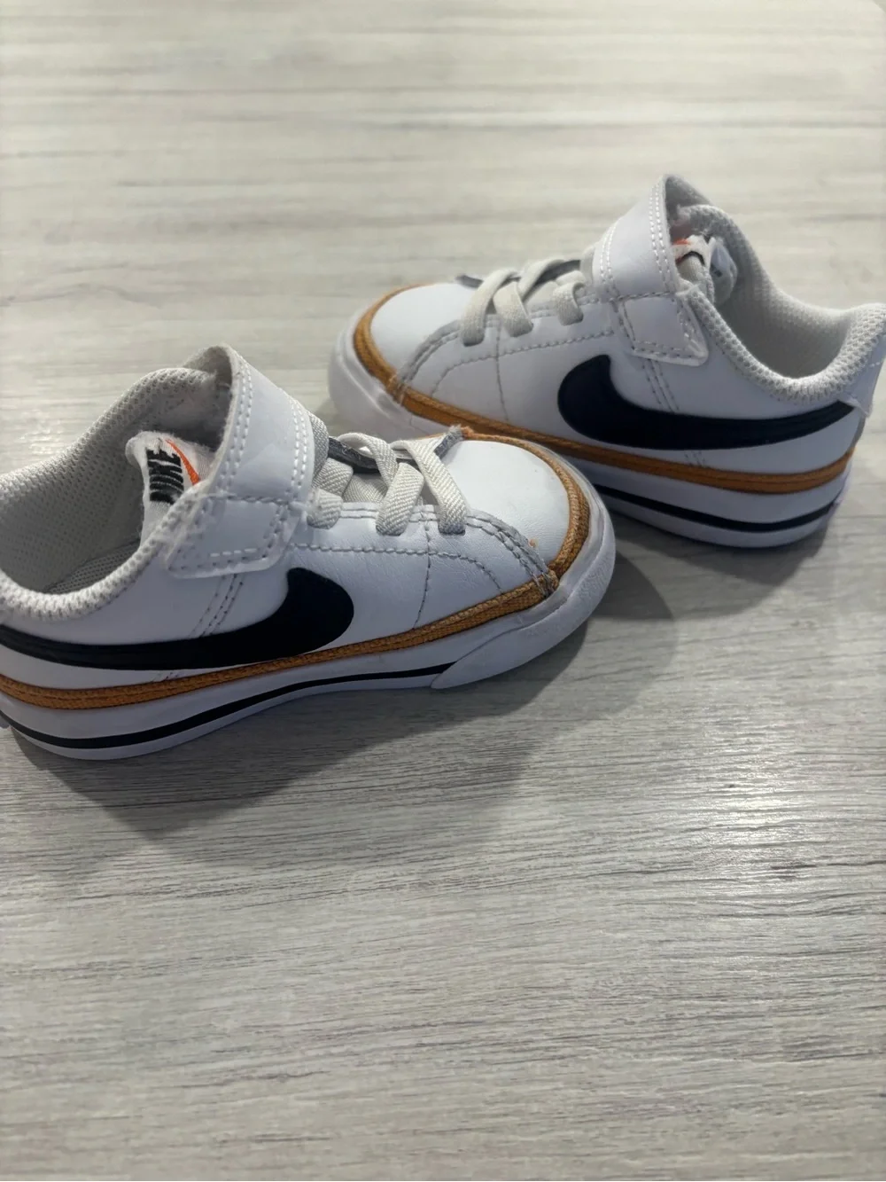Nike Kids White Sneakers with Black Swoosh and Brown Trim
